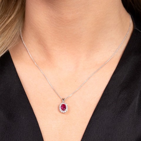 18ct white gold 0.95ct ruby oval and diamond 0.31ct halo pendant