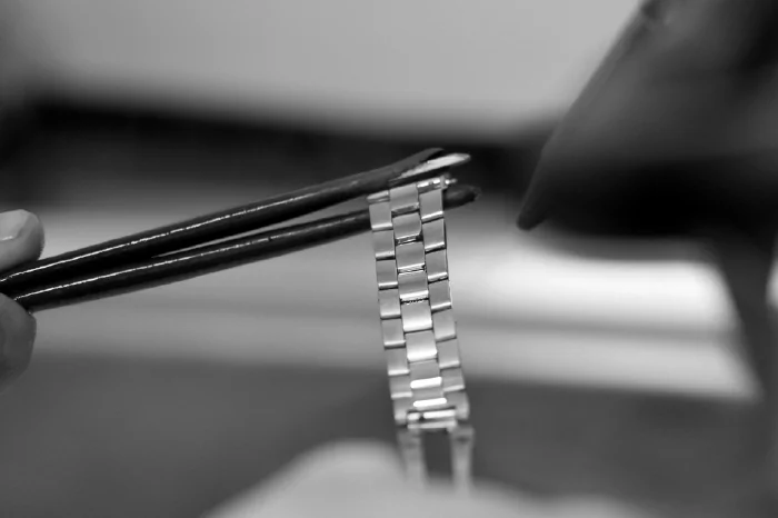 Bracelet Link Adjustments (Image: watch bracelet being repaired)