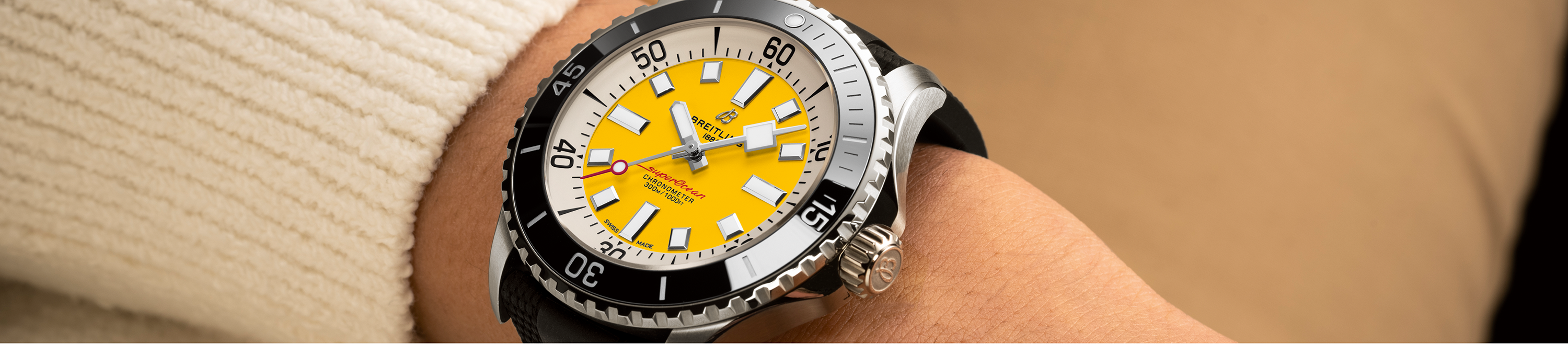 still life of the breitling superocean automatic code yellow watch on wrist 