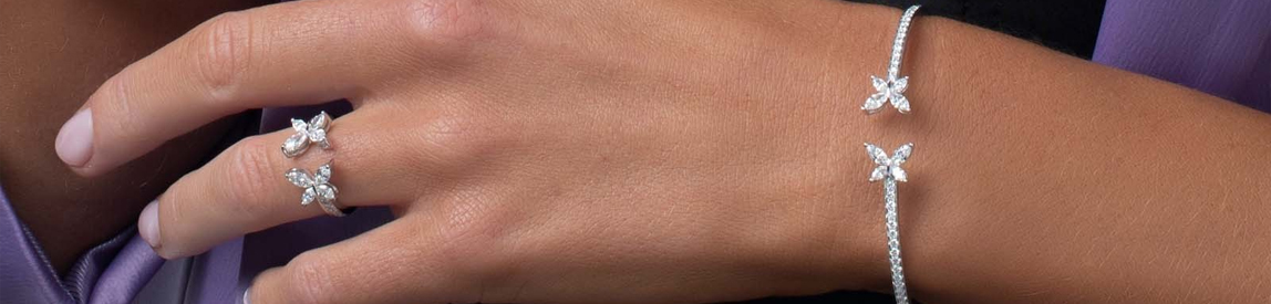 Matching diamond necklace and ring on model.
