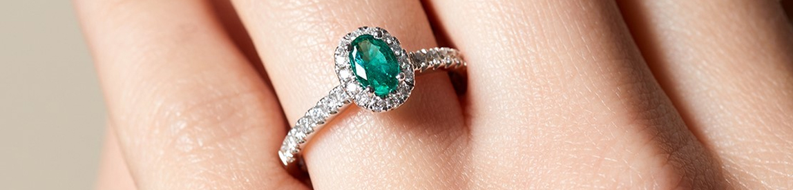 emerald and diamond ring​ on model