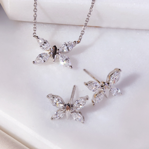 Jewellery Sets (Image: White Gold butterfly necklace and earrings against white surface)