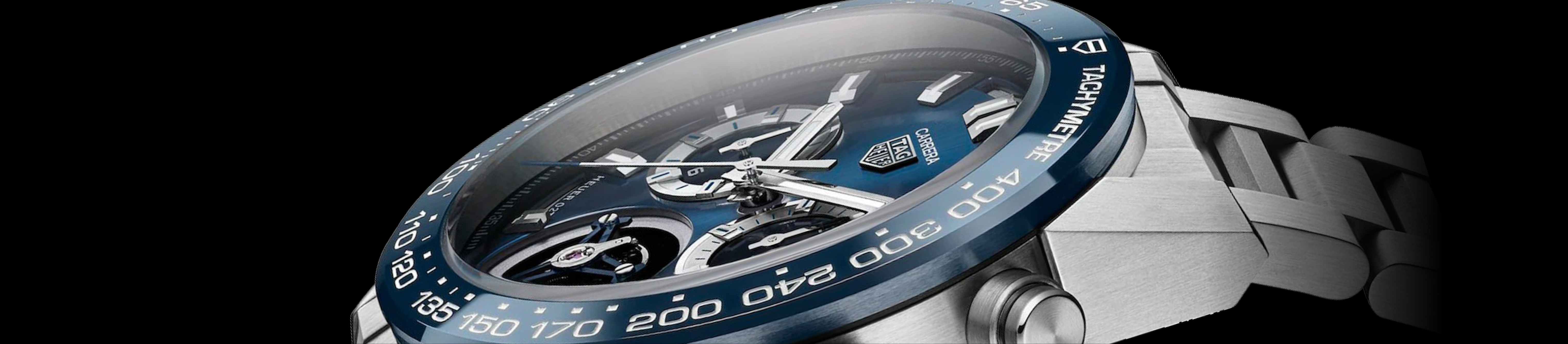 close up of tag heuer watch with blue face an bezel