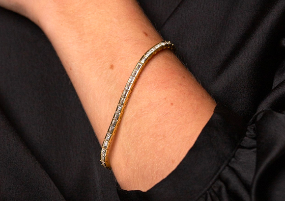 Sale Jewellery (image: woman wearing a yellow gold diamond bracelet)