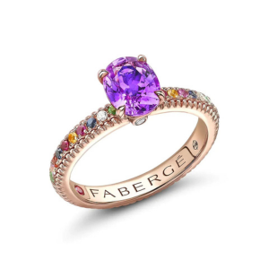 Gold faberge ring with purple sapphire stone mounted on top of other gemstones
