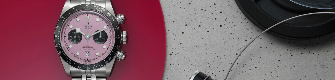 still life of tudor black bay chrono pink watch