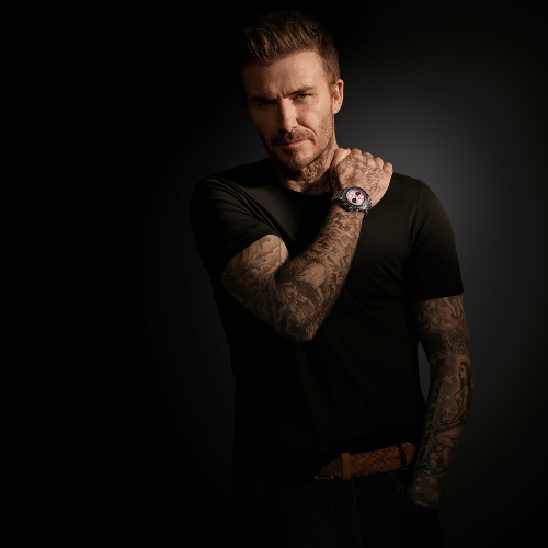 david beckham modelling tudor black bay chrono pink watch with black background 